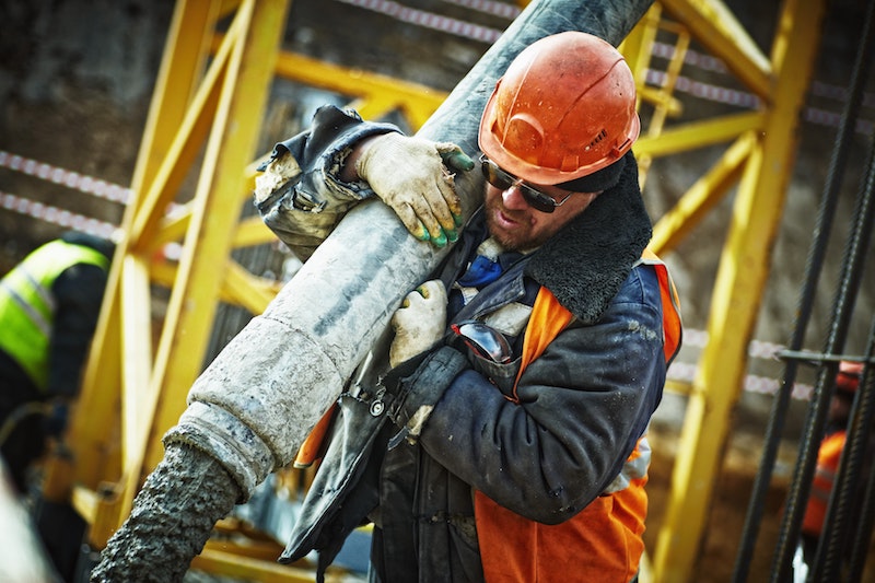 Construction worker carrying a heavy load