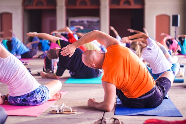 Cost of yoga people practicing yoga in studio