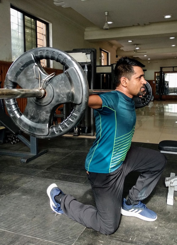 Man doing lunges in the gym