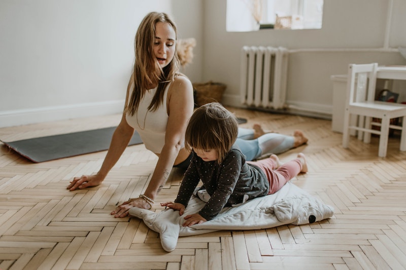 Mom exercising at home with toddler