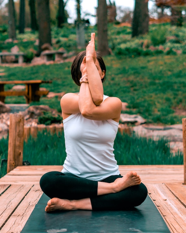 A woman holding a yoga twist pose