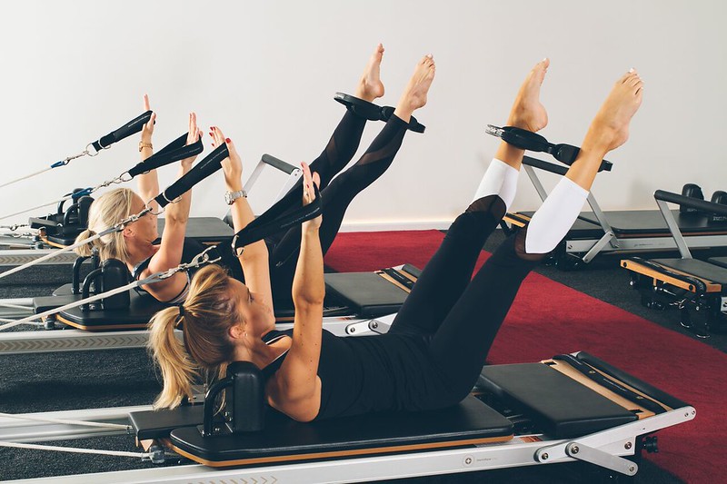 Women doing pilates on reformer