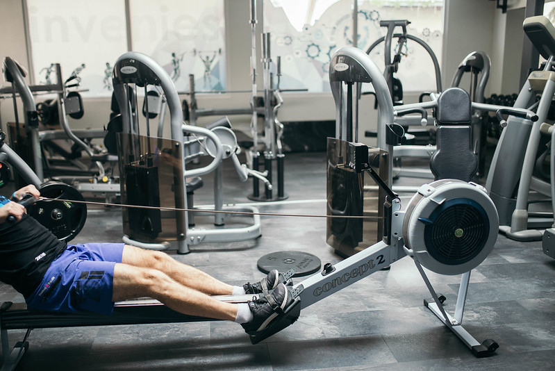 Man exercising on rowing machine