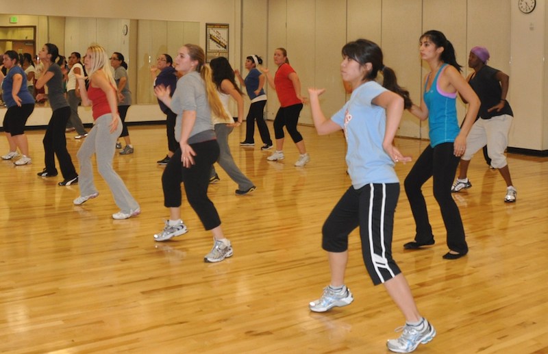 A zumba dance class in a gymnasium