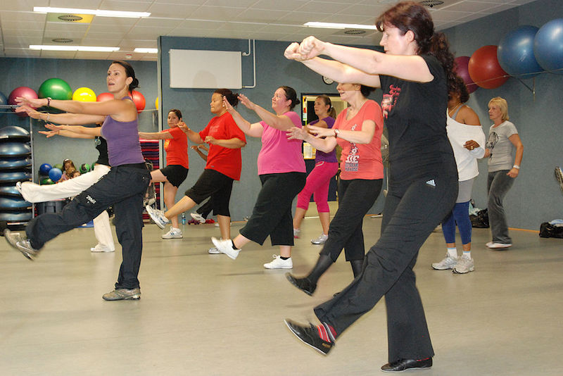 Class of women doing zumba exercise