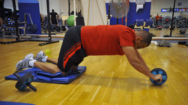 Man using an ab wheel with proper form