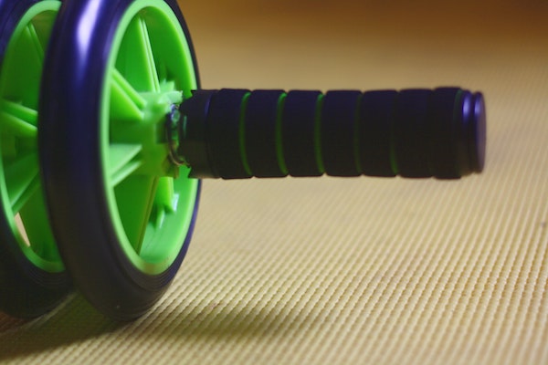 An ab wheel roller sitting on an exercise mat