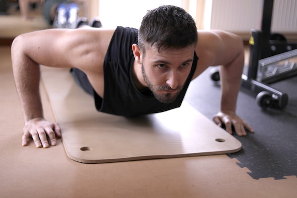 Man doing push ups on gym floor
