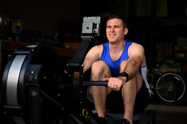 Man using rowing machine at gym