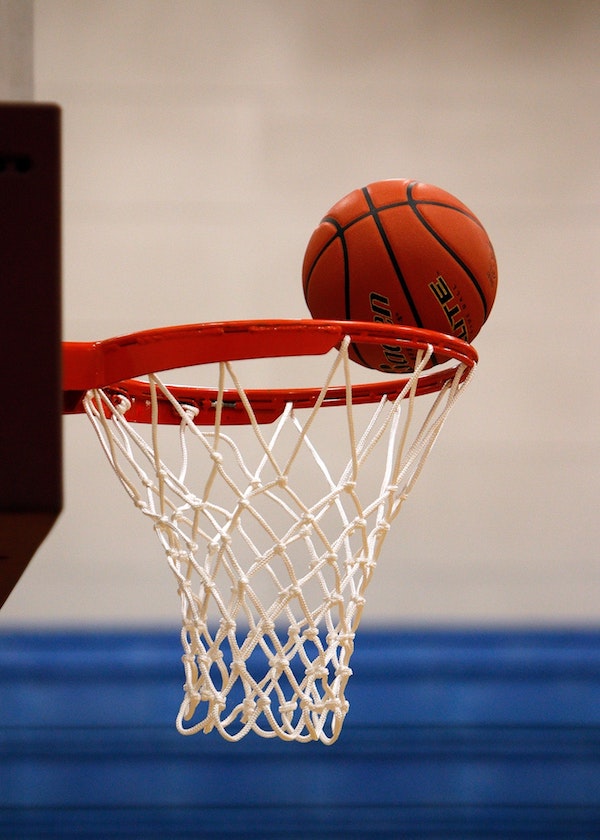 Ball on rim of basketball net