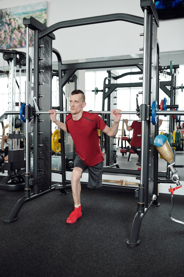 Man doing lunges in power rack