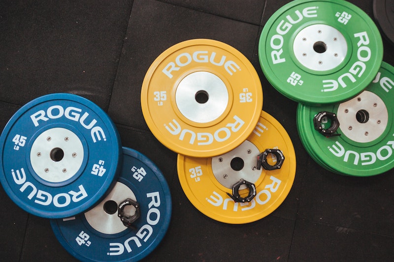 Olympic plates laying on an exercise mat