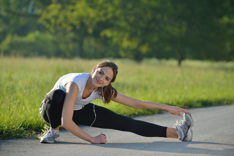 Woman stretching before a run outside