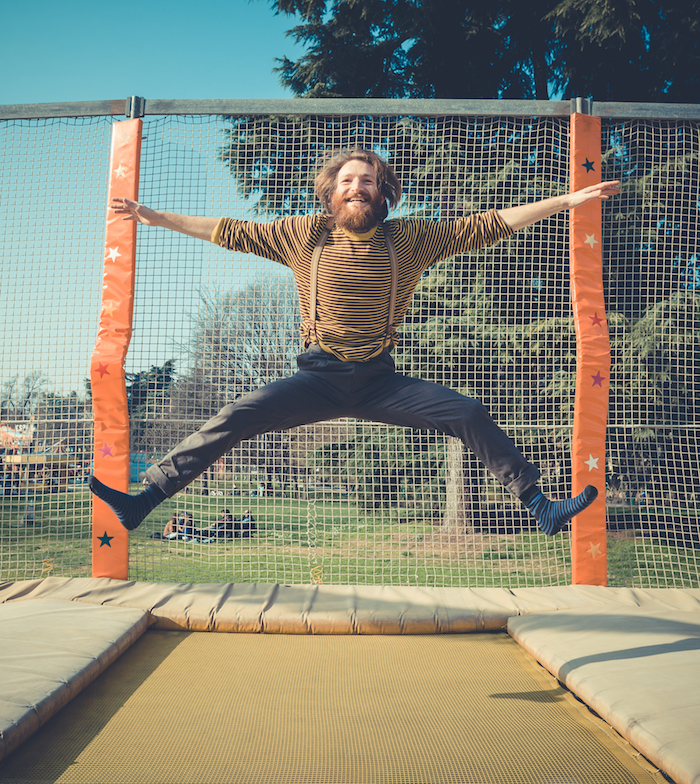 Man jumping excitedly on trampoline