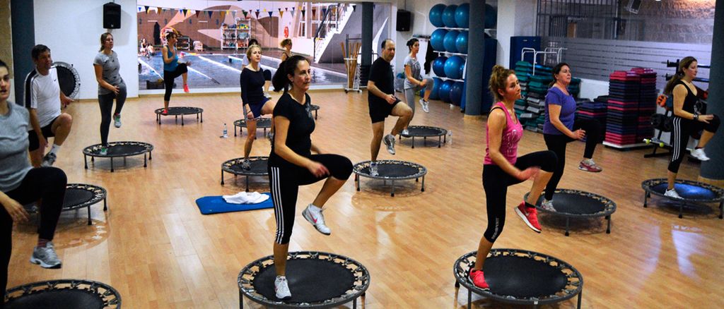 Group jumping during trampoline fitness class