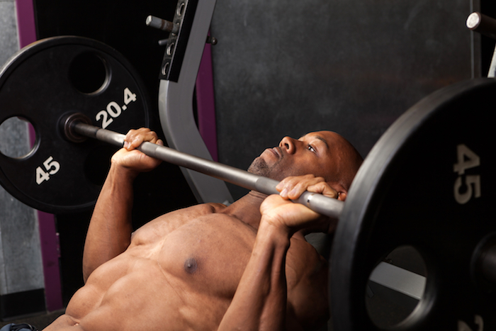 Man performing incline bench press